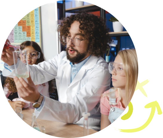 Man helping elementary school children in a science lab