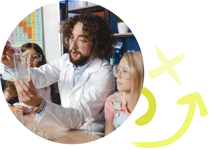 Man helping elementary school children in a science lab